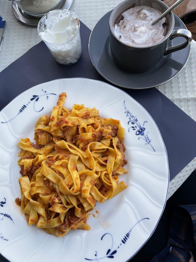 Outdoor market in Italy with vendors selling fresh produce and local delicacies, showcasing the affordable and authentic food options available to budget travelers