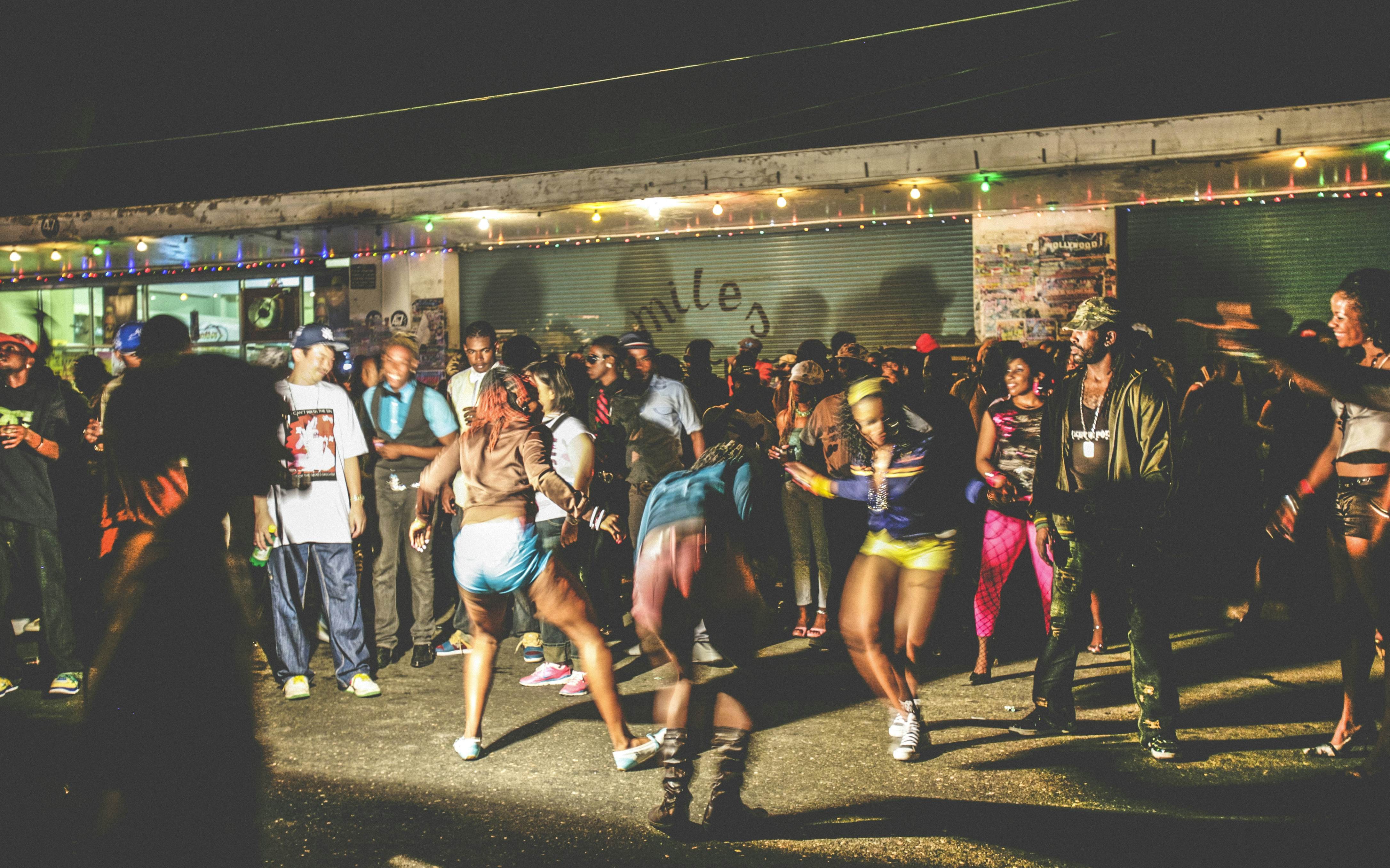 A dancehall party with people dancing and celebrating
