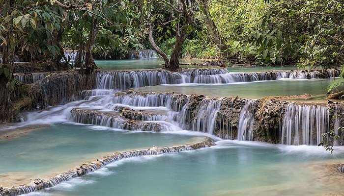 Kuang Si Falls and its emerald water pools in Luang Prabang, Laos showcasing the natural beauty of the area