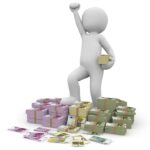 Figurine on stacks of money symbolizing agency fees
