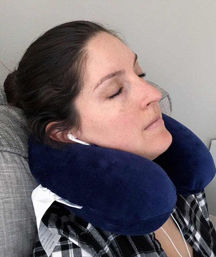 Woman using a TravelMate Neck Support Pillow
