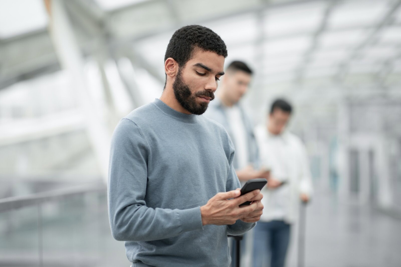 Man on probation using a phone in an airport