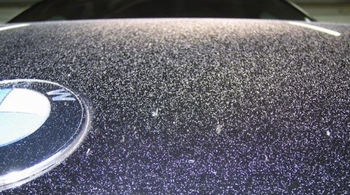Overspray on a car, illustrating potential damage