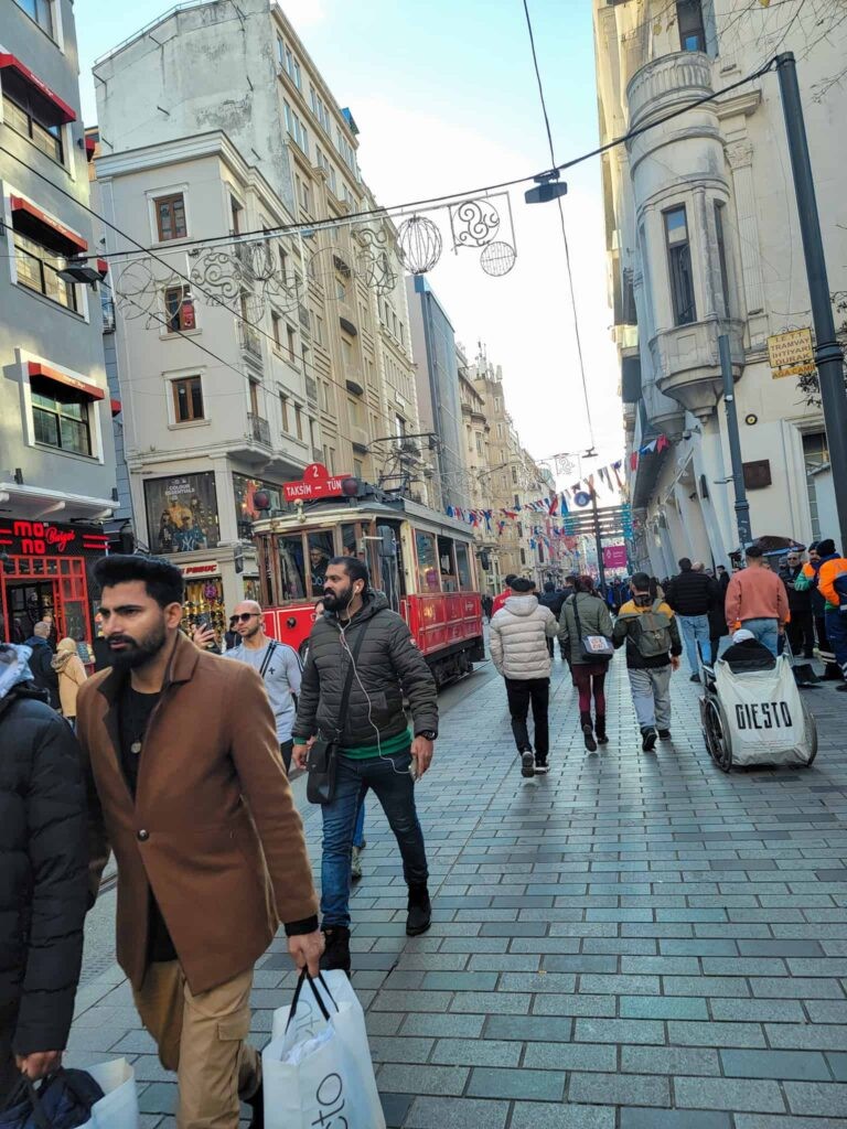 A woman confidently navigating a bustling street in Istanbul's historic district