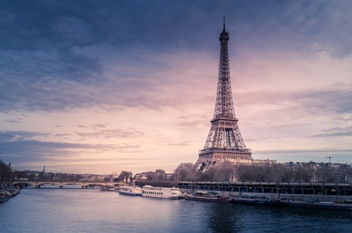 Eiffel Tower in Paris under a dramatic sky