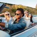 Group of friends smiling on road trip