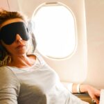 Woman using a neck pillow on a plane