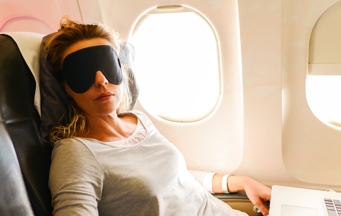 Woman using a neck pillow on a plane