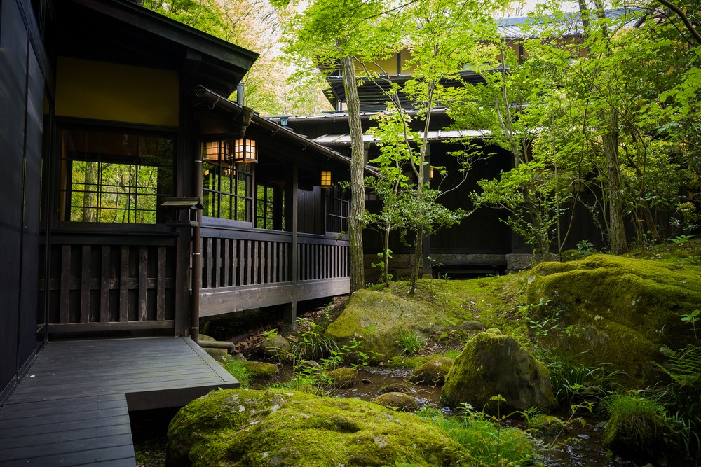 A traditional onsen ryokan hot spring inn Japanese hotel in the middle of nature. The Japanese hotel is a great way to experience Japanese culture.