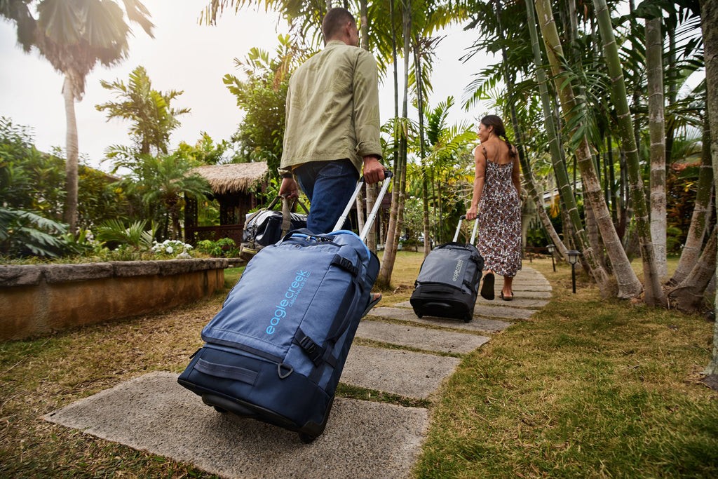 Rolling carry-on bags in an airport