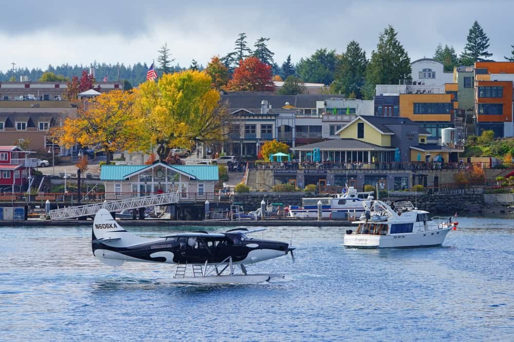 A view of San Juan Islands showing boats sailing on the clear waters with forested islands in the background.