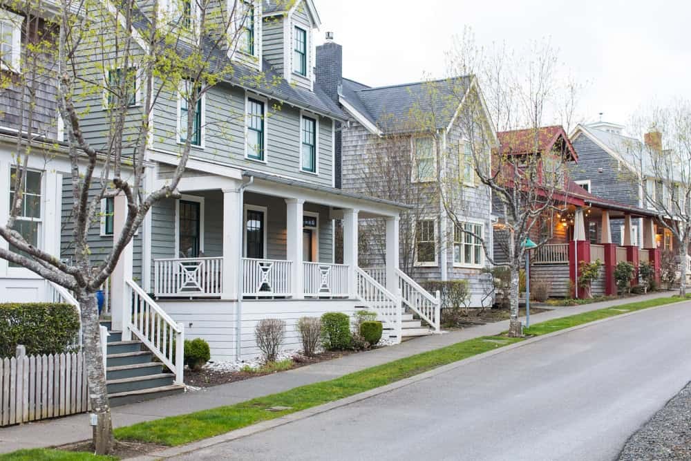 A street in Seabrook shows colorful houses and shops in a charming coastal town setting.