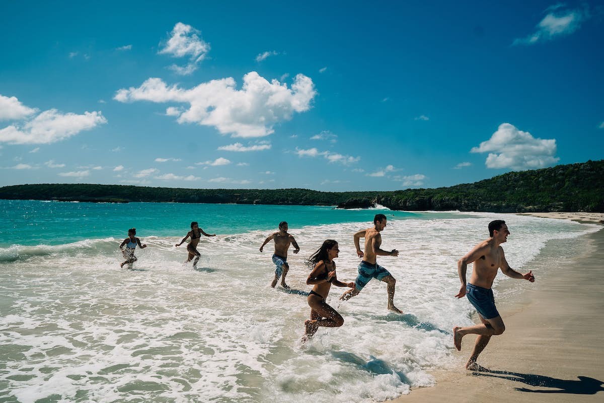 A family running out of the sea at Caracas Beach in Vieques