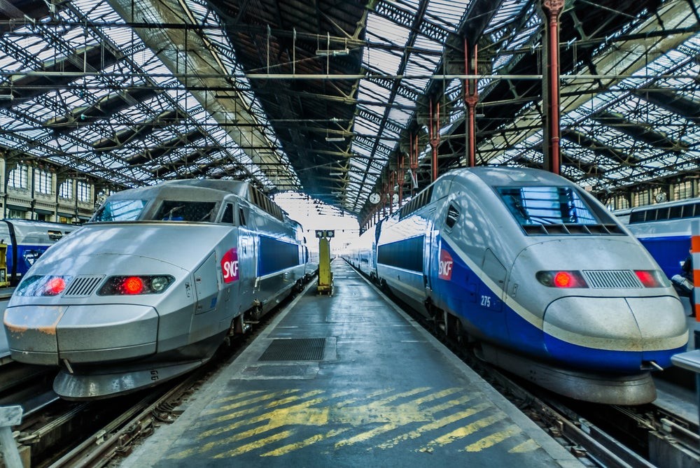 An interior view of a bullet train, showcasing the comfortable seating and spacious environment conducive to relaxation