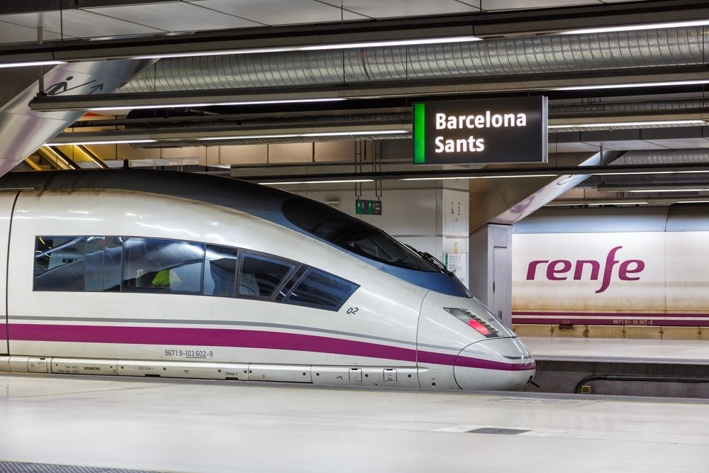 A Renfe AVE train at Barcelona Sants railway station, showcasing its modern design and efficiency