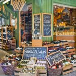 Alcohol and cheese on display at a stall in Viktualien open air market in Munich.