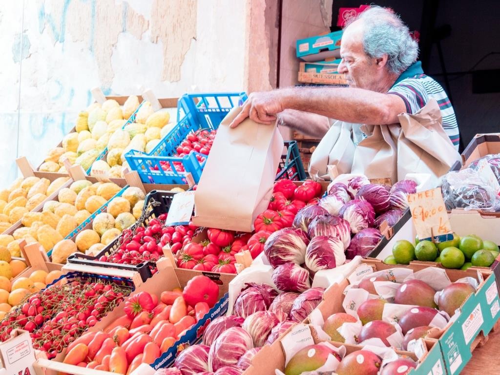 A bustling street in Palermo, Sicily, showcasing the vibrant atmosphere and friendly locals