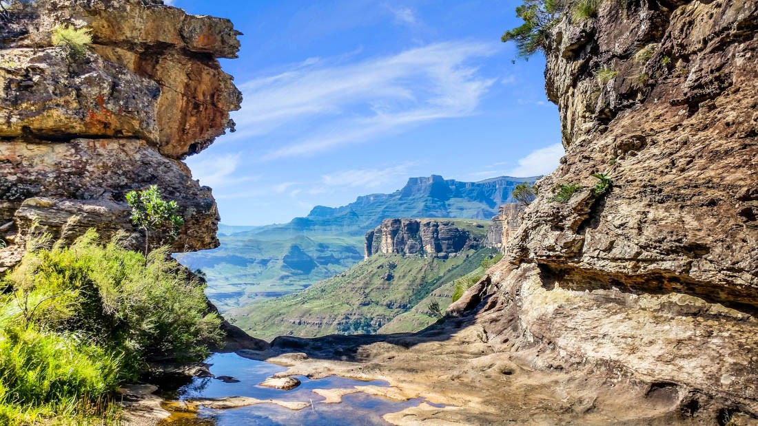 Drakensberg Mountains, South Africa. A wider view showcasing the expansive landscape of the Drakensberg Mountains, with lush greenery and varied terrain
