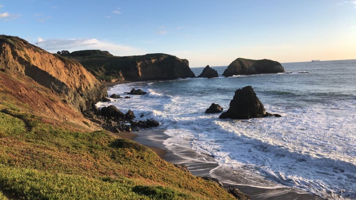 A solo traveler enjoying the views from a San Francisco beach