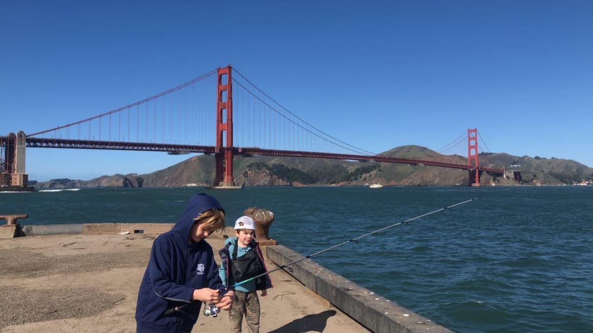 A family enjoying a day of fishing near the Golden Gate Bridge