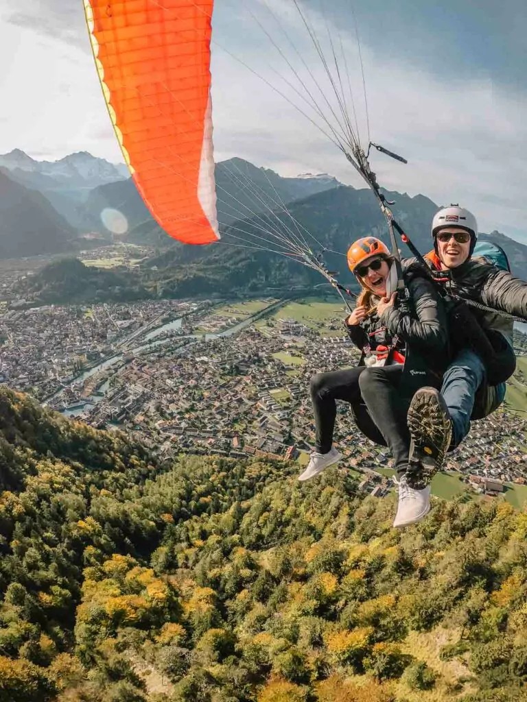 A thrilling paragliding adventure over Interlaken, capturing the stunning Swiss landscape from above, and illustrating the diverse activities available during a ten day exploration of Switzerland