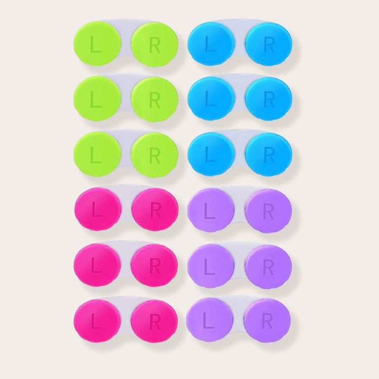 Contact lens cases filled with different makeup products, illustrating a compact and creative way to travel with cosmetics