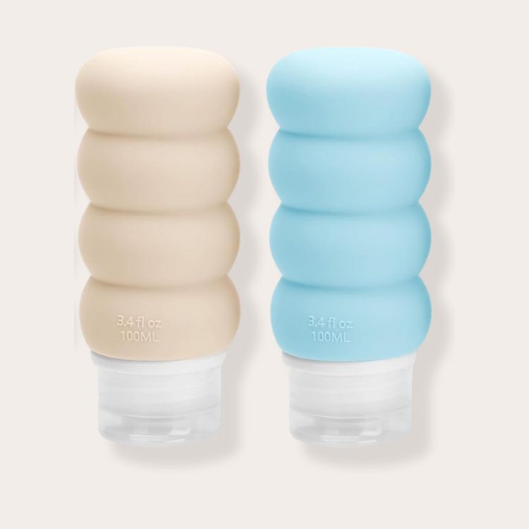 Refillable toiletry bottles displayed on a bathroom counter, showcasing a practical packing solution for air travel