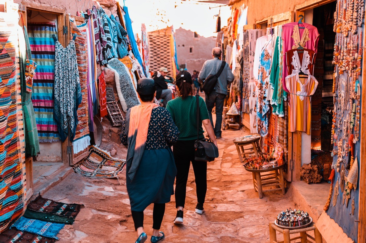 Couple walking through a vibrant Marrakech market
