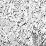 Close-up of aluminum foil being wrapped around food