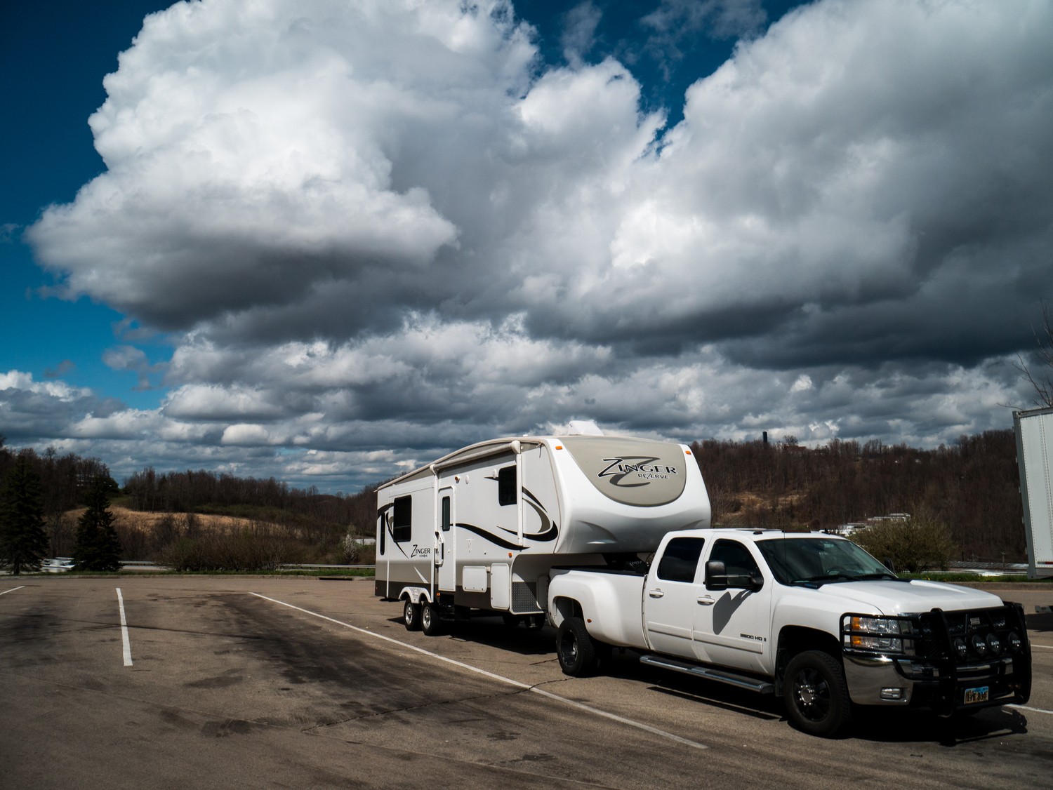 Couple enjoying nature near their parked travel trailer