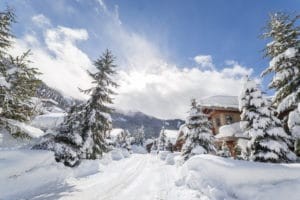 A vibrant scene in Whistler, British Columbia, capturing the lively atmosphere of the town during the winter season with skiers and snowboarders enjoying the slopes.