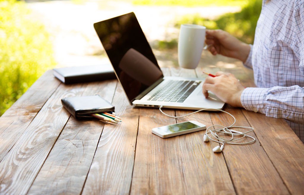 Laptop and notebook at a desk